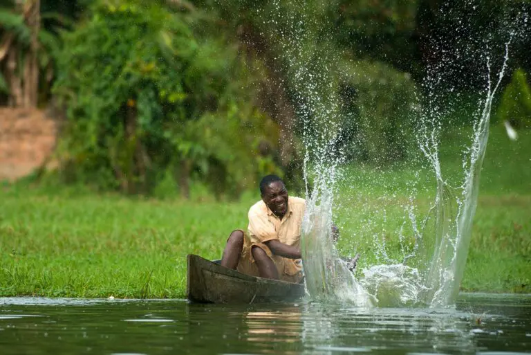 Uganda fisherman on dug out canoe in Lake Victoria Entebbe