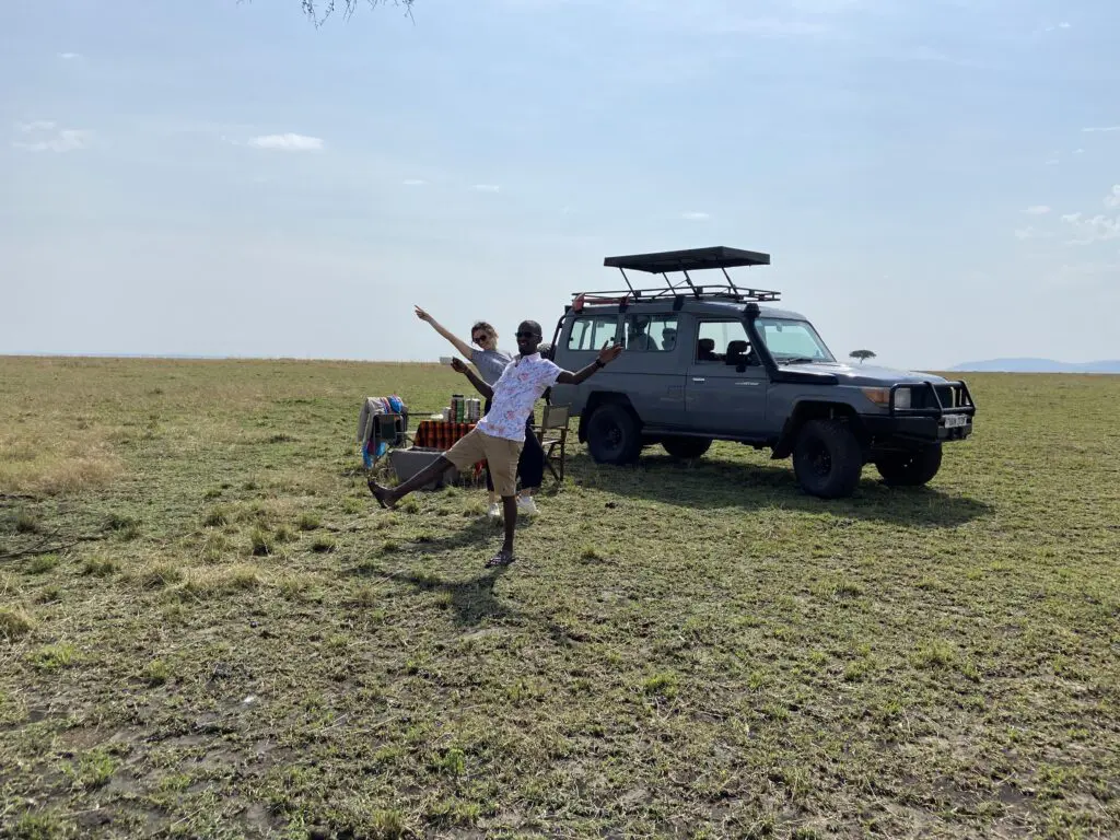 Landcruiser with popup roof in masai mara two people having fun