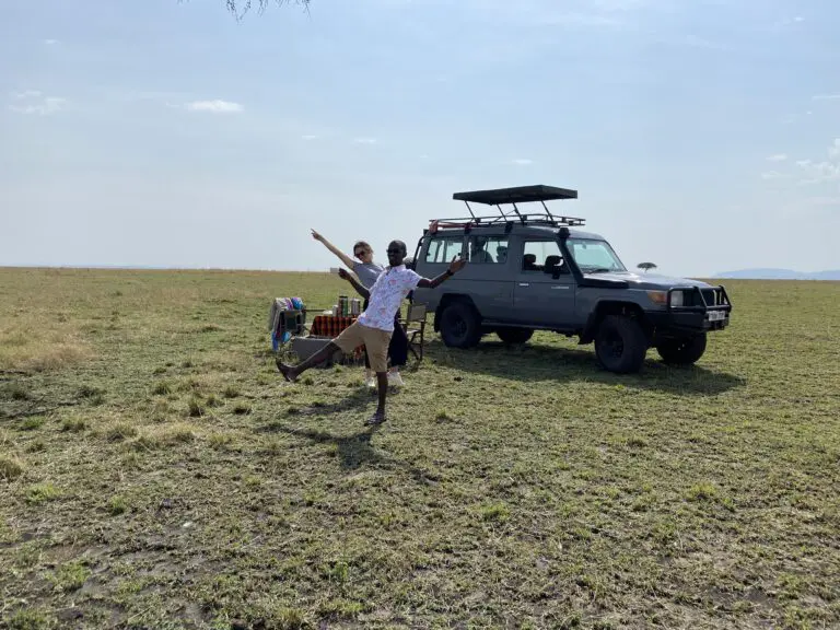 Landcruiser with popup roof in masai mara two people having fun