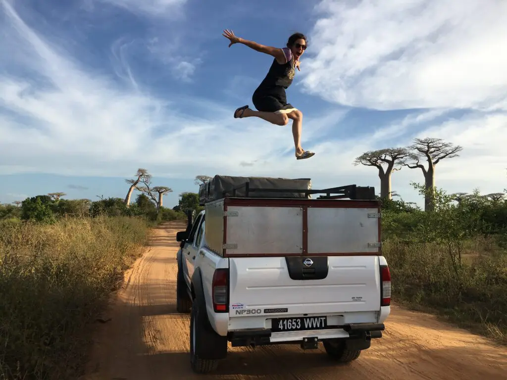 Women Jumping on car Baobab De Avenue roadtrip madagascar